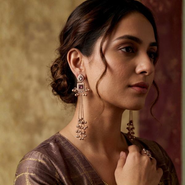 pink stone kashmiri earrings on woman