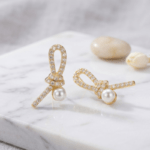 Fashion Gold Tone Ribbon Knot Pearl Stud Earrings for Women and Teen Girls, Elegant Crystal Rhinestone Bow Jewelry - Image 2